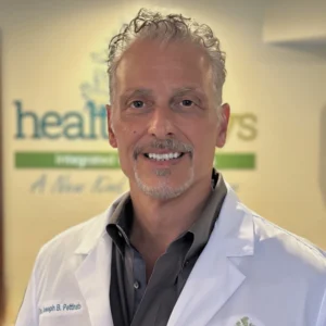 Dr. Joseph Pettinato, chiropractor, smiling in his Gibsonia clinic