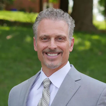About Us 1 Dr. Joseph Pettinato, chiropractor, smiling in his Gibsonia clinic
